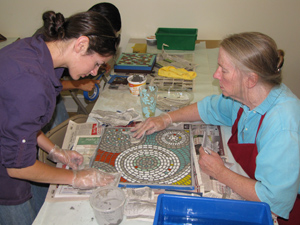 Students working with instructor help on their intermediate table project.